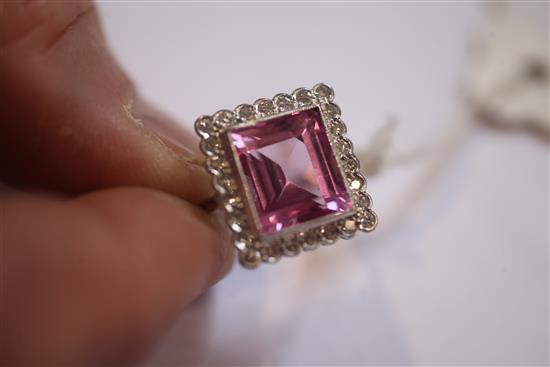 A 18ct white gold, synthetic pink sapphire and diamond cluster dress ring, size K.